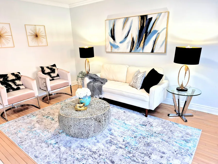 Contemporary living room staged in black, white, blue, and gold