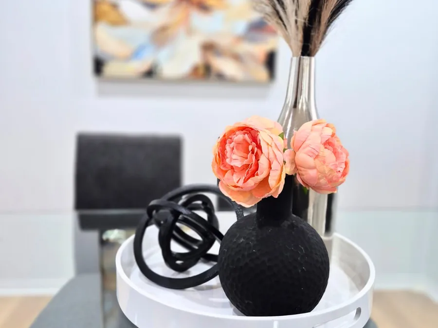 Dining table vignette with coral flowers and sculptural decor